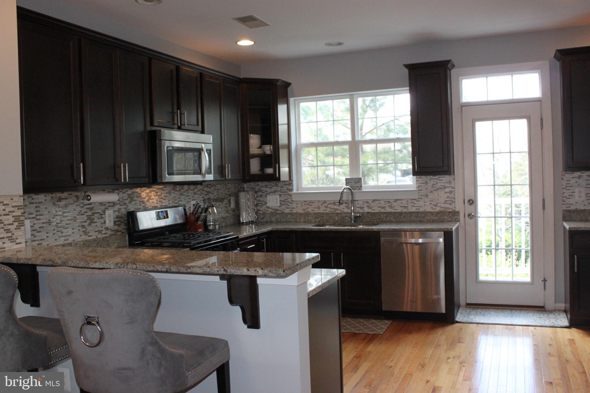 7452 Riding Meadow Way Manassas, VA 20111 - Photo 5 of 22 Modern kitchen with sleek finishes.