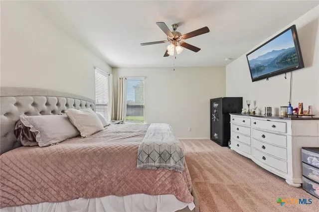 a large bed sitting in a bedroom and dresser