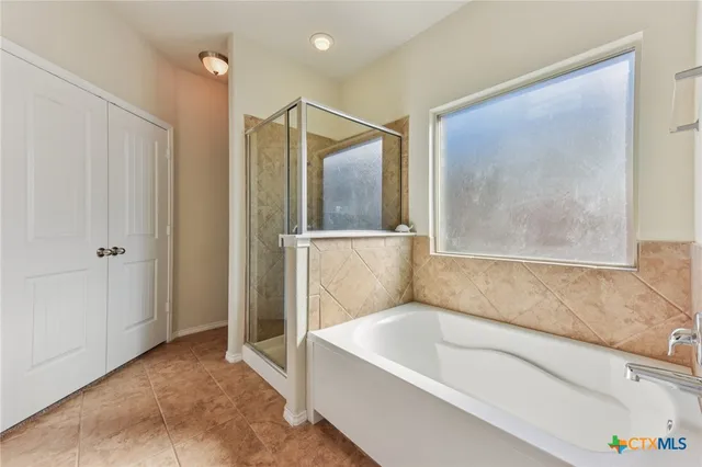 a bathroom with a tub and shower