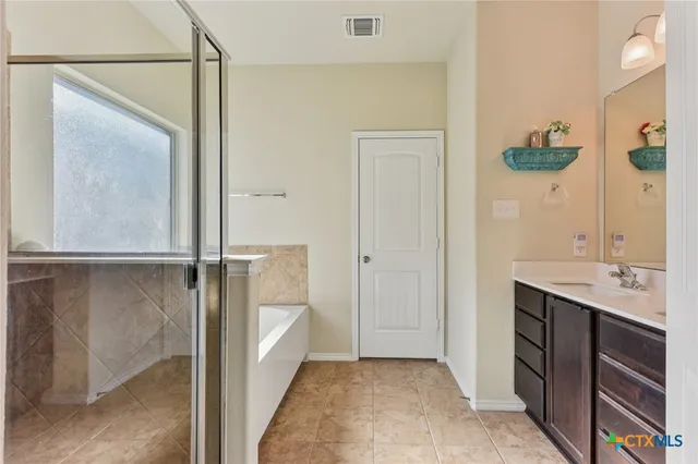 a bathroom with a double vanity sink and mirror