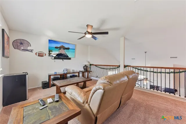a living room with furniture a rug and a chandelier