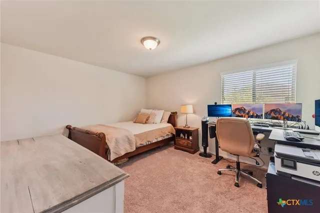 a bedroom with furniture and a window