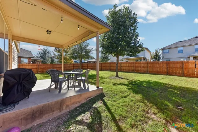 a view of a backyard with sitting area