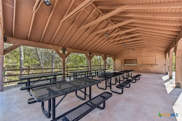 a view of a patio with table and chairs