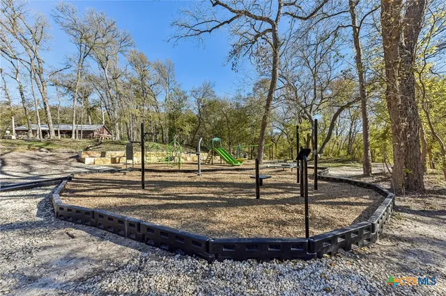 a view of a yard with large trees