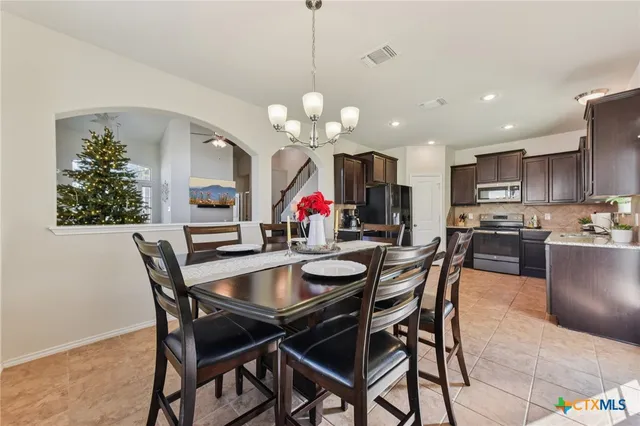 a view of a dining room with furniture and chandelier