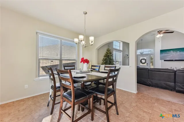 a view of a dining room and livingroom with furniture window and wooden floor
