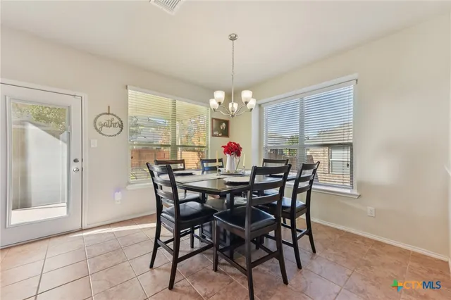 a view of a dining room with furniture window and outside view