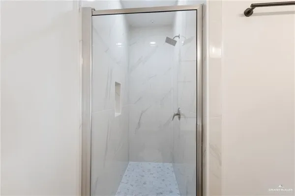 a bathroom with a glass shower door