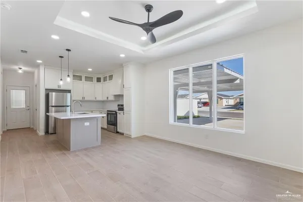a large kitchen with a large window and stainless steel appliances