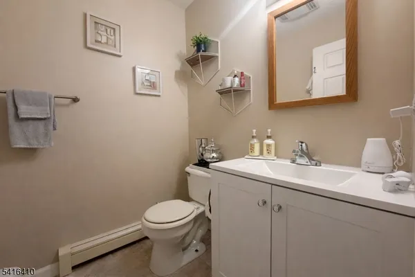 a bathroom with a sink mirror and toilet