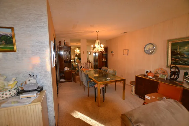 a living room with furniture a dining table and a fireplace