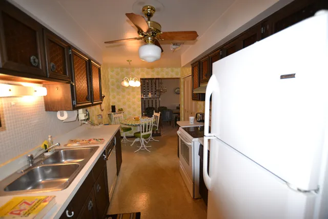 a kitchen with stainless steel appliances granite countertop sink stove and refrigerator