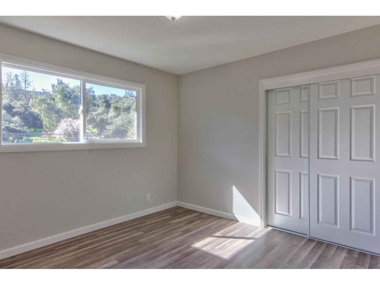 19265 Mallory Canyon Road Salinas, CA 93907 - Photo 12 of 17 a view of an empty room with wooden floor and a window