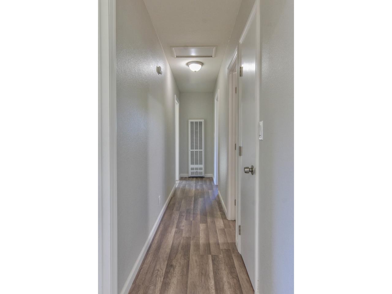 19265 Mallory Canyon Road Salinas, CA 93907 - Photo 6 of 17 a view of a hallway with wooden floor