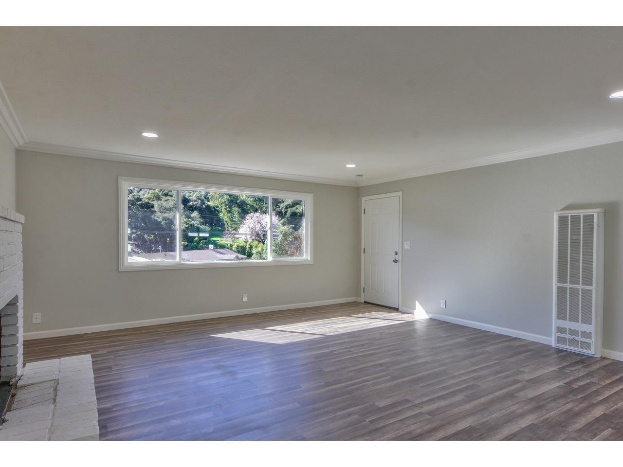 19265 Mallory Canyon Road Salinas, CA 93907 - Photo 7 of 17 a view of an empty room with wooden floor and a window
