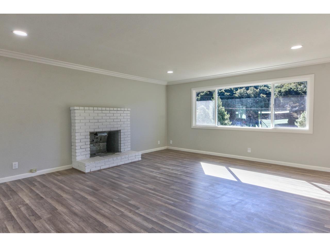 19265 Mallory Canyon Road Salinas, CA 93907 - Photo 8 of 17 a view of an empty room with wooden floor and a window
