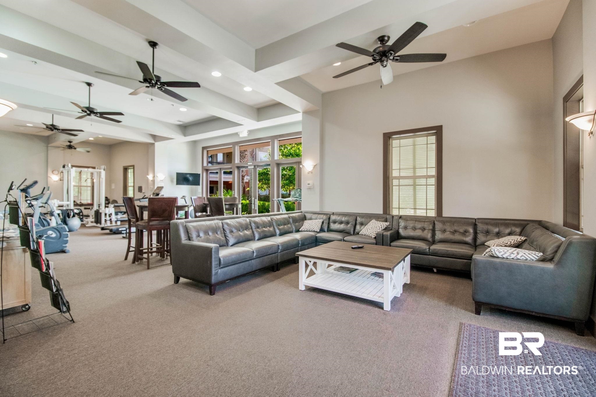 1430 Regency Road, Unit I201 Gulf Shores, AL 36542 - Photo 33 of 34 Carpeted living room featuring ceiling fan and beamed ceiling