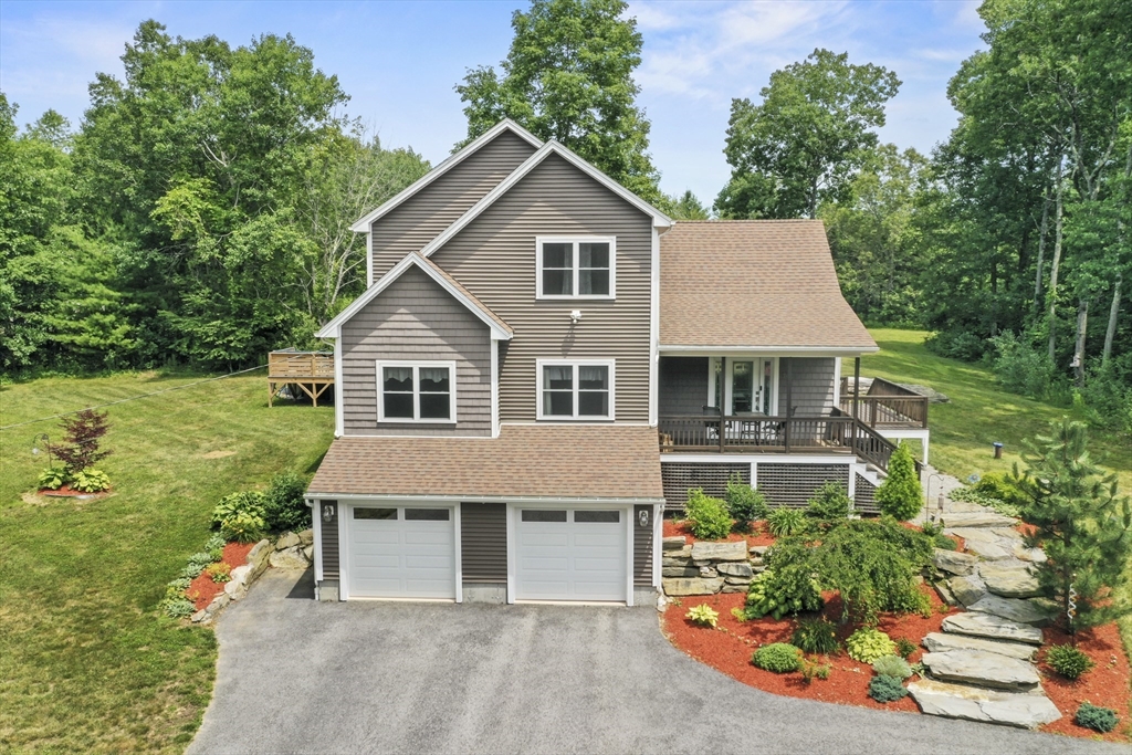 74 Baker Pond Road Dudley, MA 01571 - Photo 1 of 42 a house with lots of trees in the background