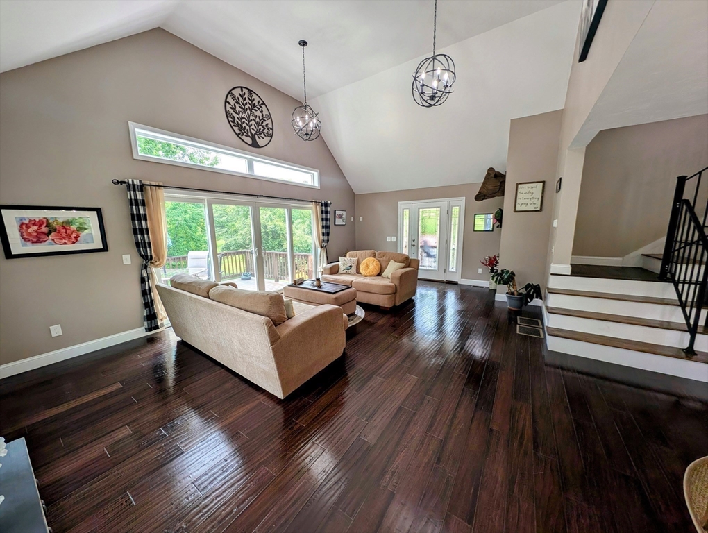 74 Baker Pond Road Dudley, MA 01571 - Photo 12 of 42 a living room with furniture and a wooden floor