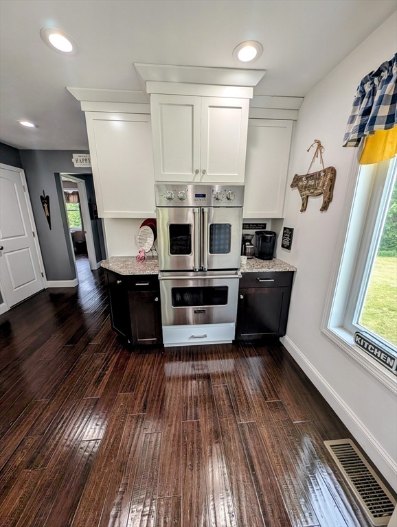 74 Baker Pond Road Dudley, MA 01571 - Photo 14 of 42 a kitchen with stainless steel appliances a stove a sink a microwave and wooden floor