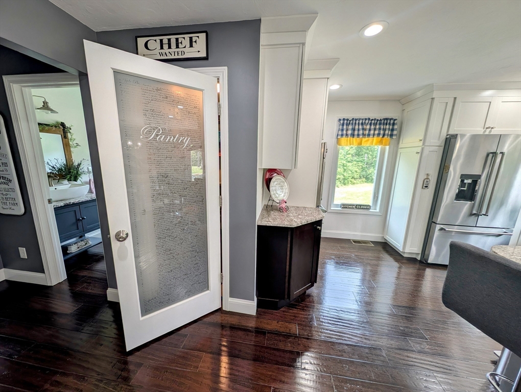 74 Baker Pond Road Dudley, MA 01571 - Photo 15 of 42 a view of a hallway with wooden floor and furniture
