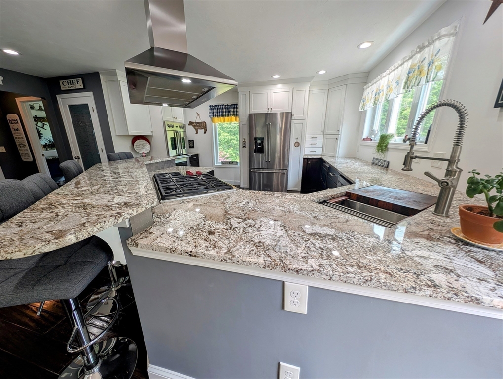 74 Baker Pond Road Dudley, MA 01571 - Photo 25 of 42 a kitchen with stainless steel appliances granite countertop sink stove and refrigerator