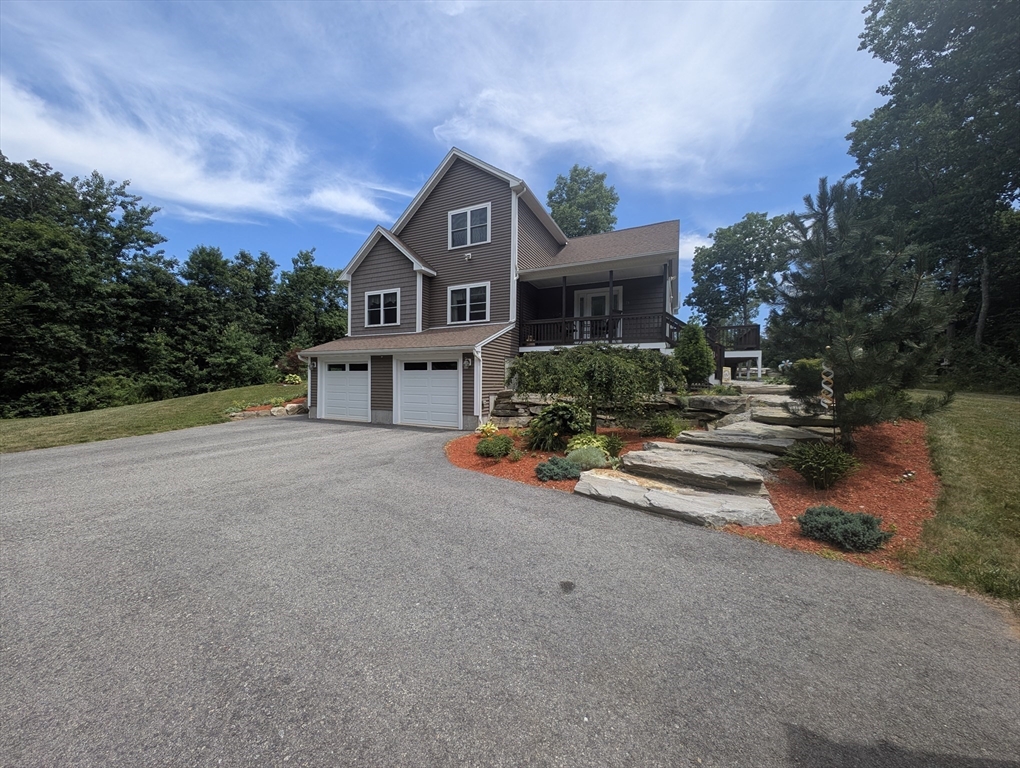 74 Baker Pond Road Dudley, MA 01571 - Photo 27 of 42 a front view of a house with a yard and garage