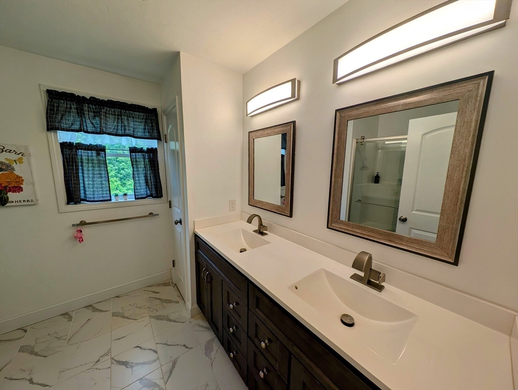 74 Baker Pond Road Dudley, MA 01571 - Photo 36 of 42 a bathroom with a double vanity sink mirror and bathtub