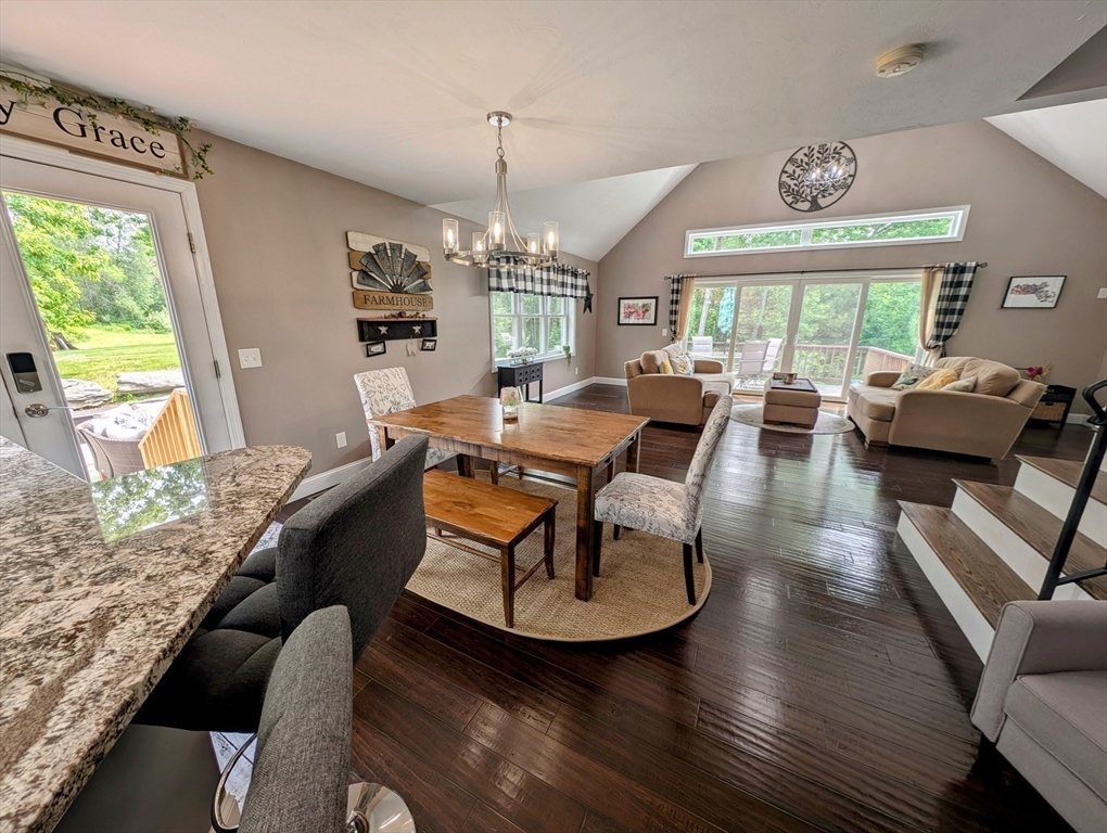 74 Baker Pond Road Dudley, MA 01571 - Photo 4 of 42 a living room with fireplace furniture and a chandelier