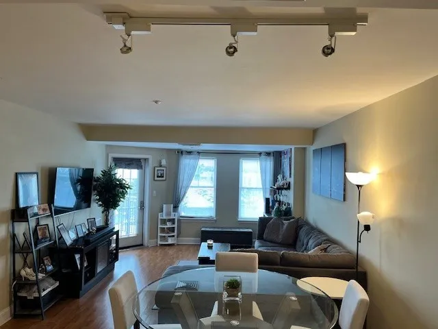 a living room with furniture and a wooden floor