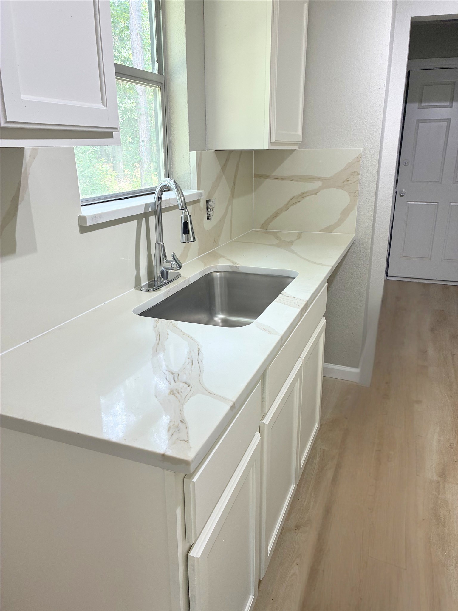 117 Amanda Street Conroe, TX 77304 - Photo 10 of 35 a kitchen with a sink and a window