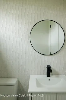 a bathroom with a sink and mirror