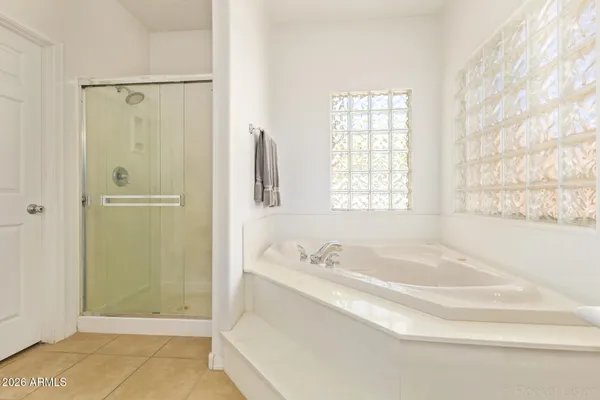 a bathroom with a granite countertop sink a shower and a bathtub
