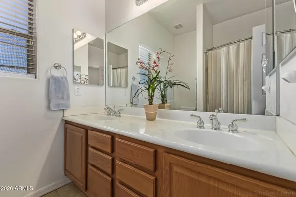 a bathroom with a double vanity sink and a mirror