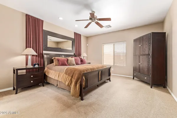 a bedroom with a bed dresser and a window