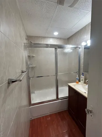 a bathroom with a sink mirror and a shower