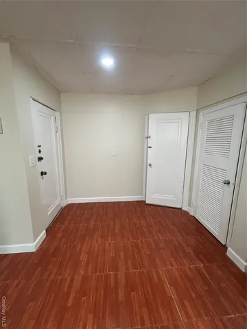 a view of an empty room and wooden floor
