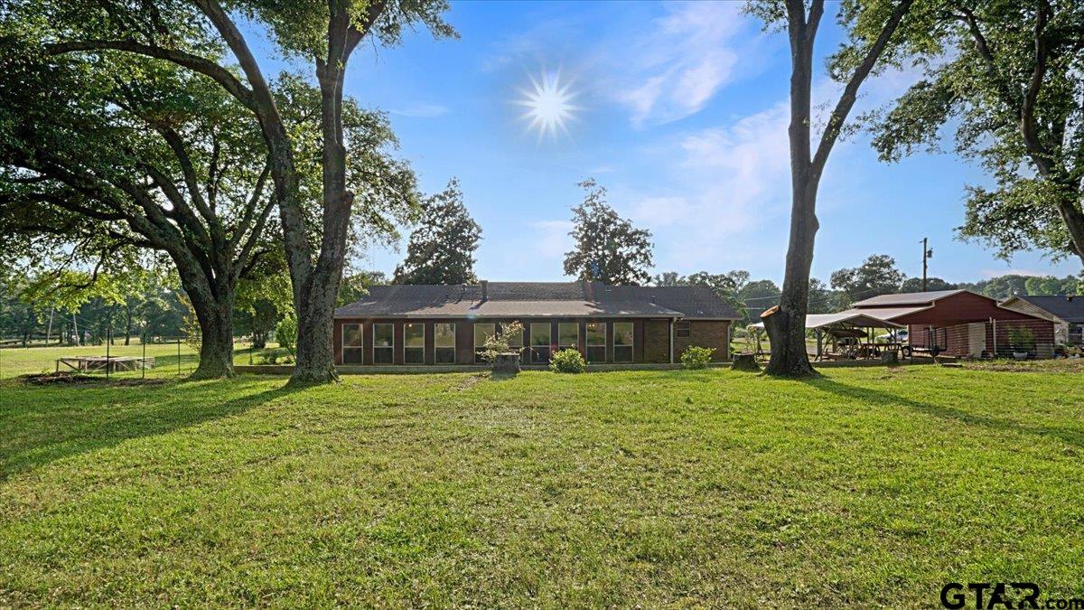 8192 County Road 428 Tyler, TX 75704 - Photo 1 of 38 a front view of a house with a garden