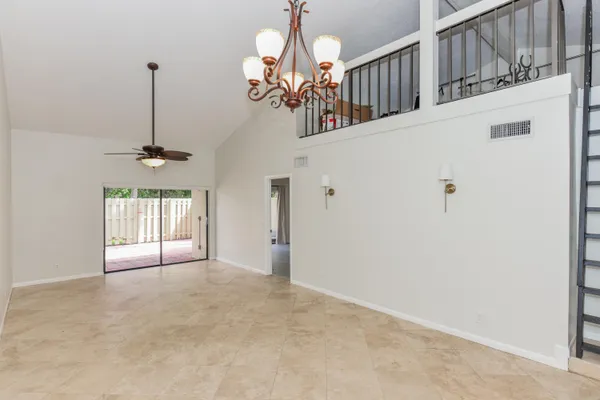 a view of a chandelier fan and entryway