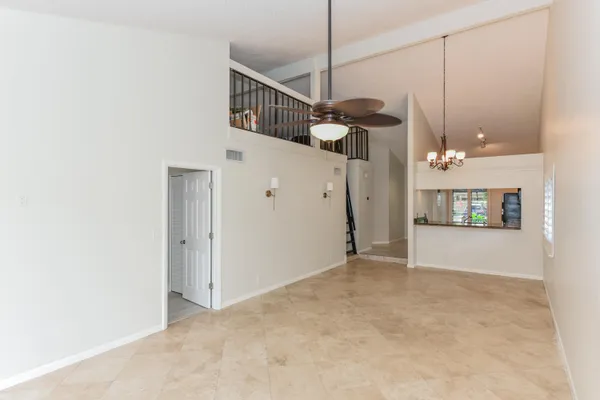 a view of an empty room with a kitchen