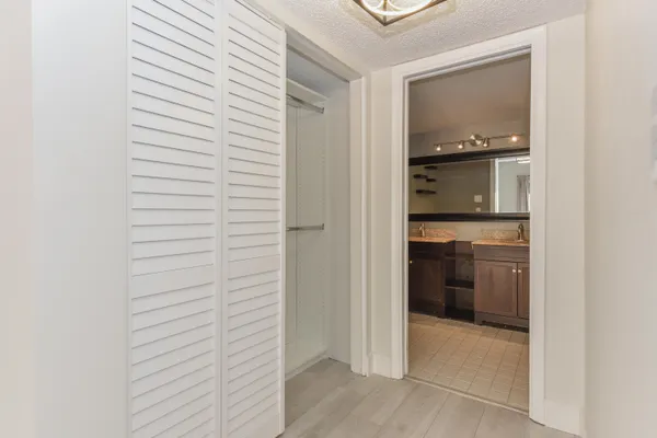 a bathroom with a toilet sink vanity and mirror