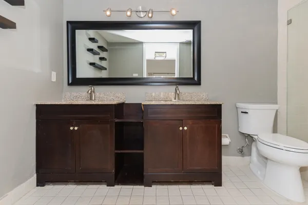 a bathroom with a sink mirror vanity and toilet