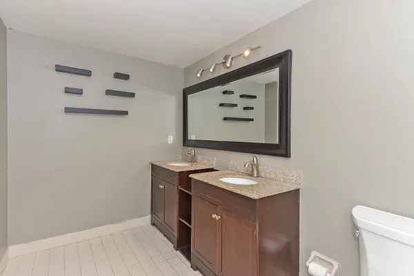 a white toilet sitting next to a shower