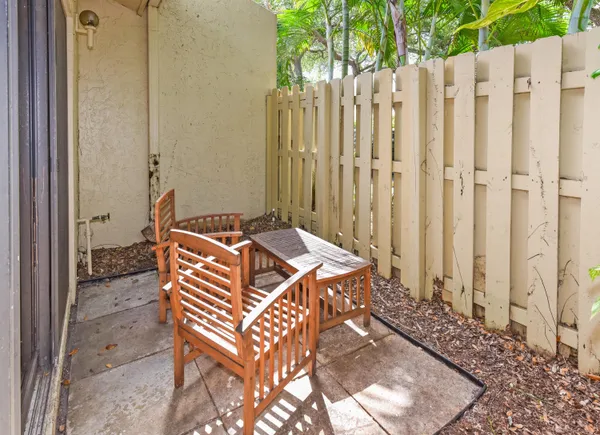 a view of a backyard with wooden fence