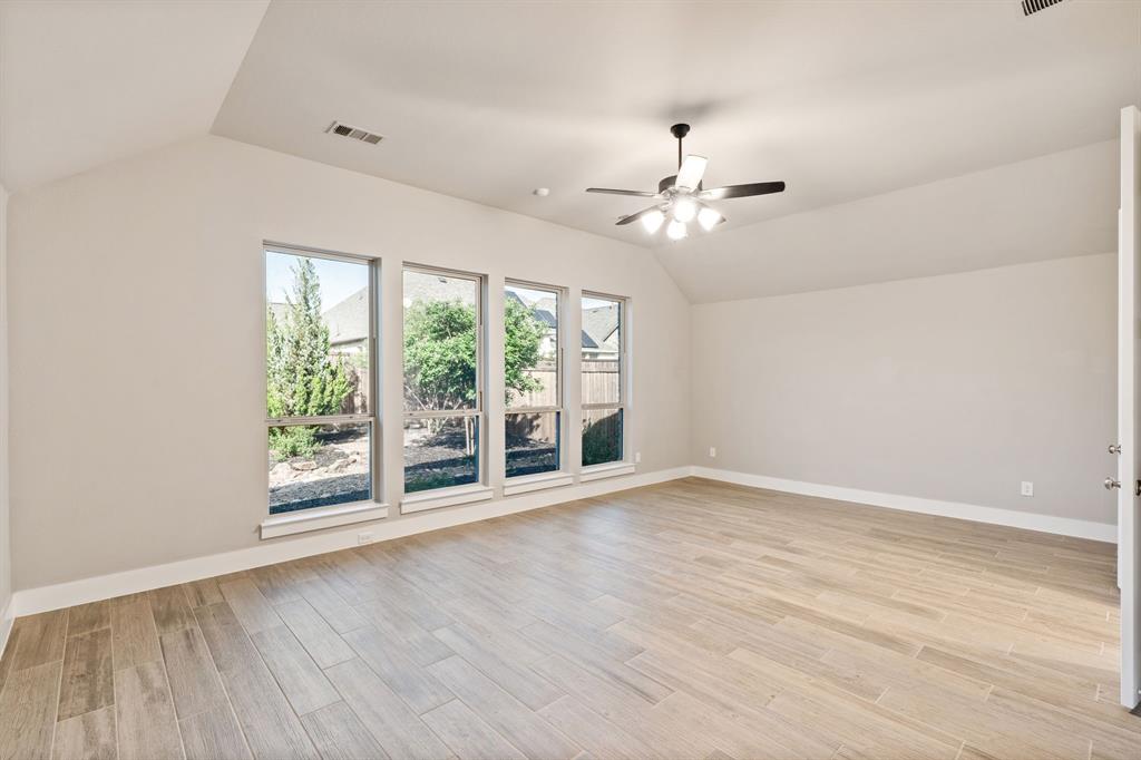 1314 Buttermere Street Forney, TX 75126 - Photo 11 of 32 wooden floor in an empty room with a window
