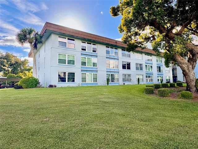 a view of a building with a yard