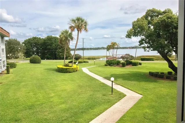 swimming pool view with a garden
