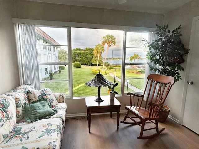 a living room with furniture and a floor to ceiling window