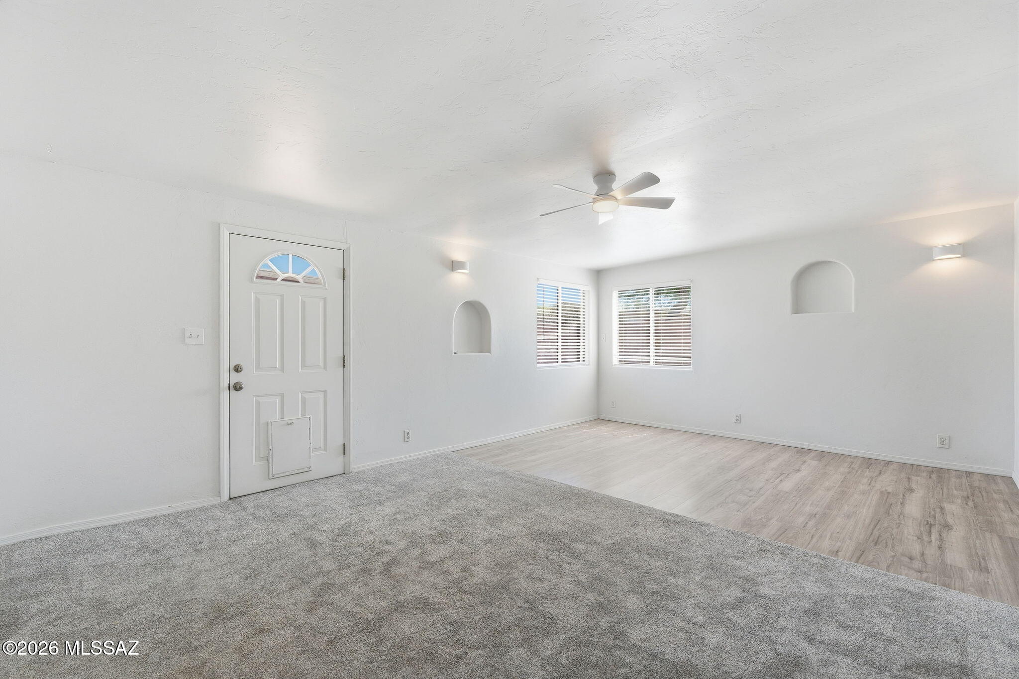 136 West Elvira Road Tucson, AZ 85756 - Photo 11 of 27 an empty room with windows and ceiling fan